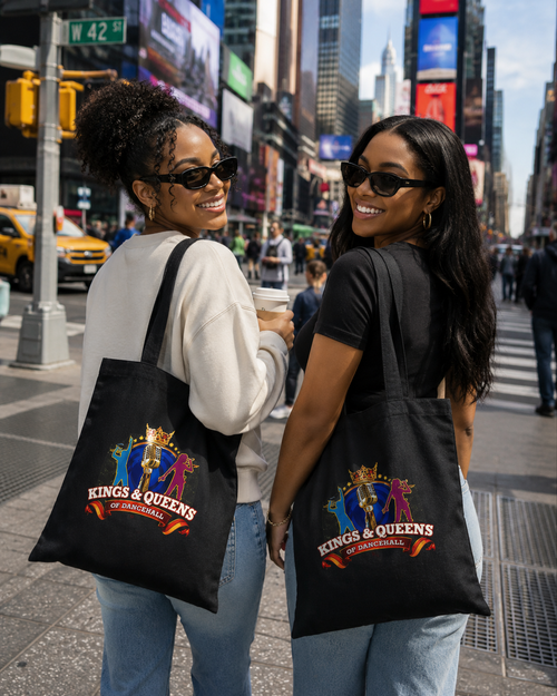 Two women carrying black Kings & Queens of Dancehall canvas tote bags with the crest, in Times Square.